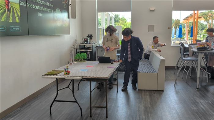 A student tests an AI-guided robot prototype in the lab.