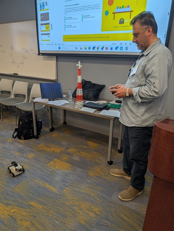 An instructor demonstrates gyroscope-driven stabilization with a remote-controlled robot.