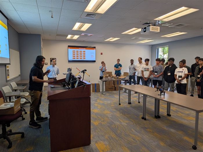 Students watch a robot navigation demo during a full-group session.